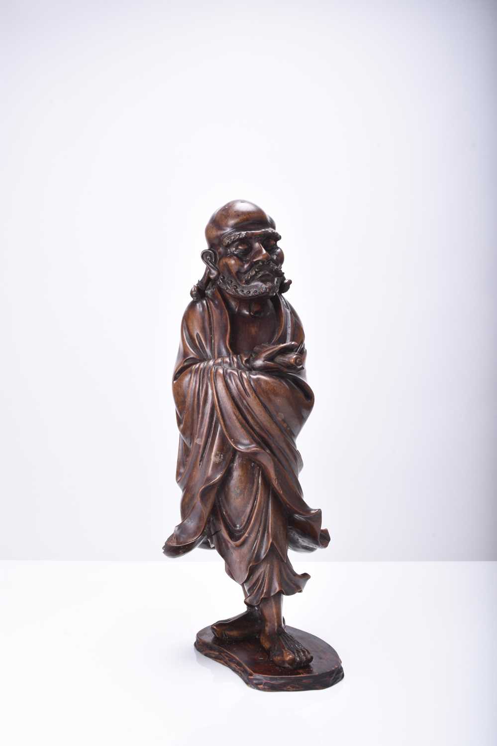 A Chinese carved wood figure of Luohan, Qing Dynasty