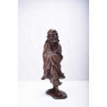 A Chinese carved wood figure of Luohan, Qing Dynasty