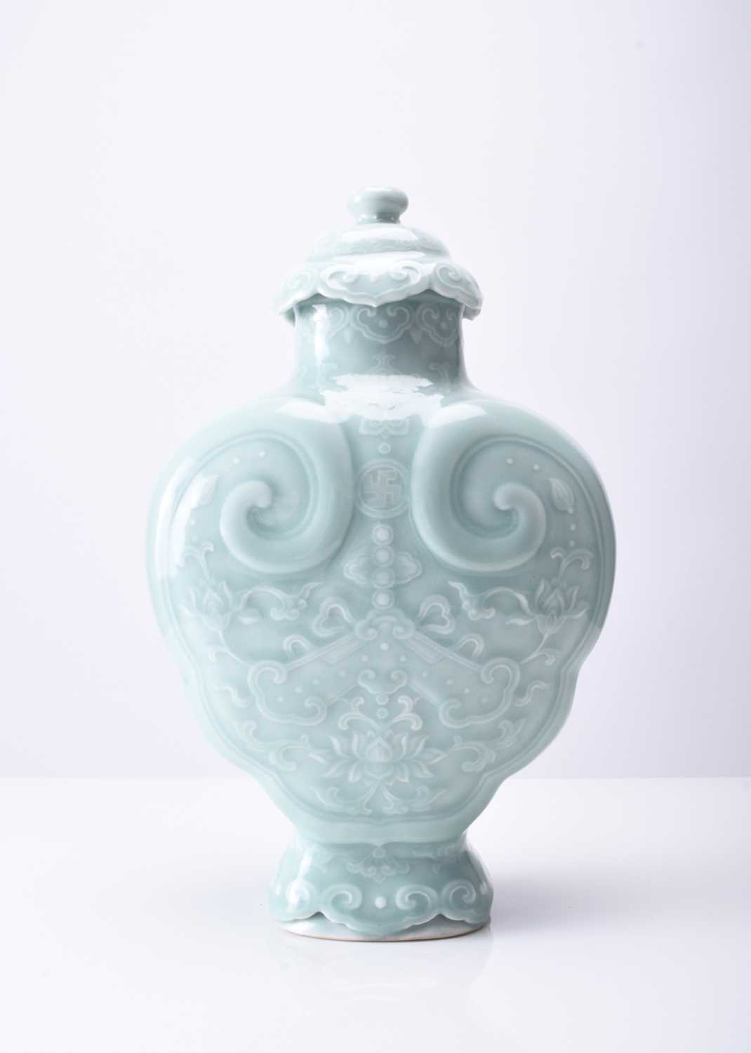 A Chinese carved celadon-glazed Ruyi vase and cover, Qianlong seal mark