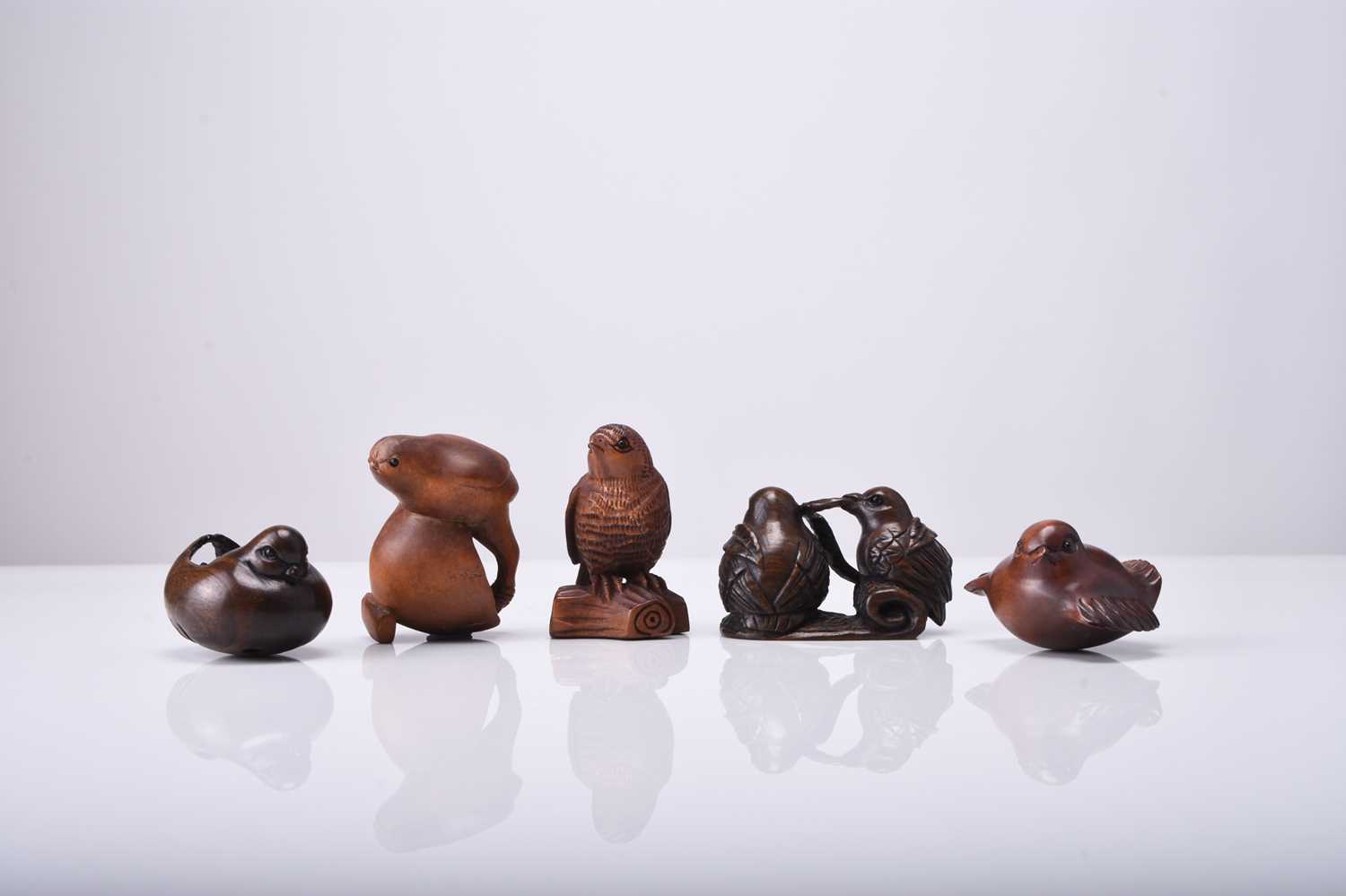 A group of five Japanese wood netsuke of birds, 20th century