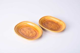 A pair of Chinese Sancai amber glazed dragon dishes