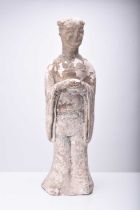 A large Chinese buff pottery figure of a maiden, Sui/Tang Dynasty
