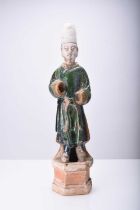 A Chinese Sancai green-glazed standing figure, Tang Dynasty