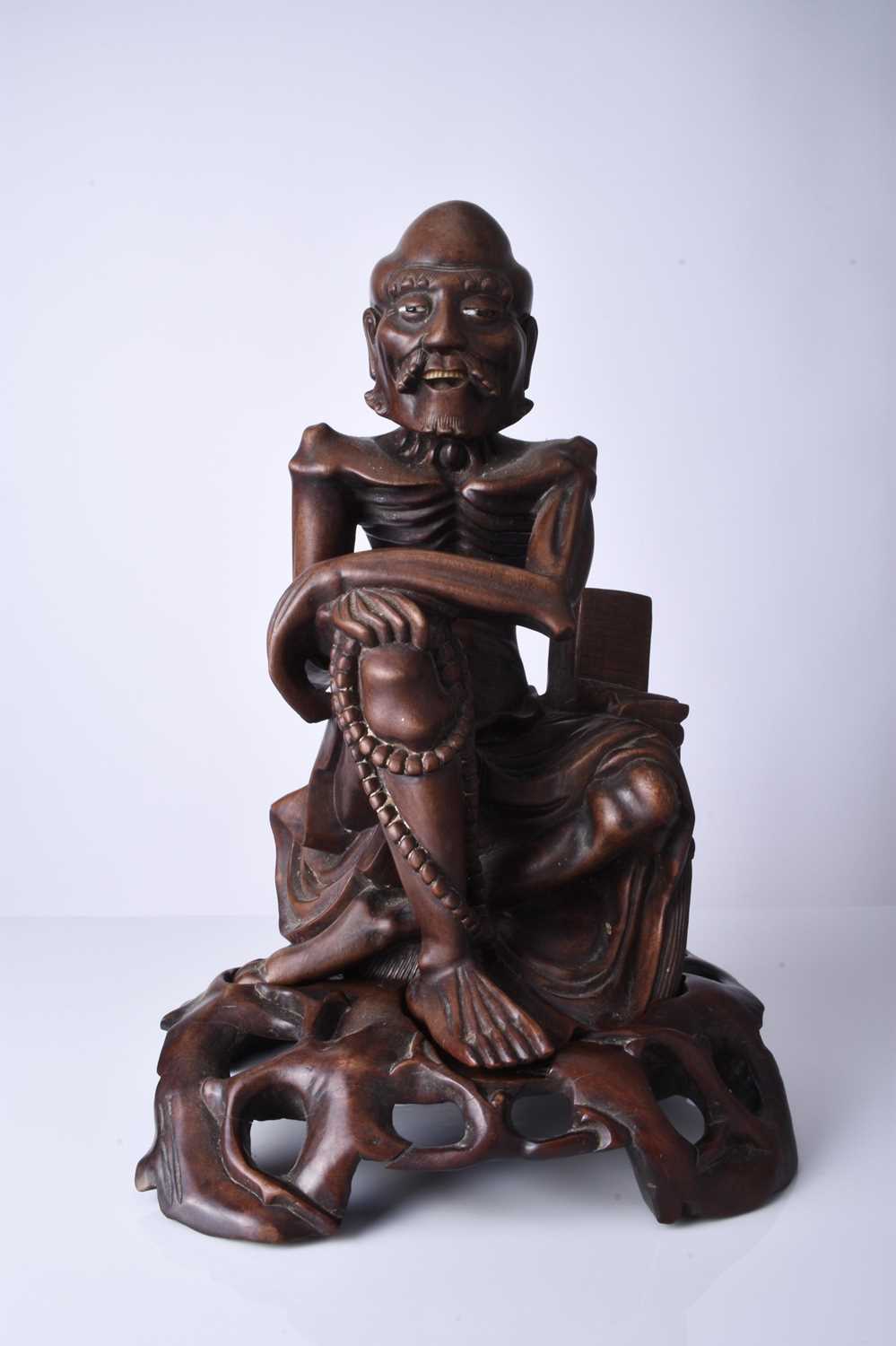 A Chinese carved hardwood figure of a luohan, 19th century