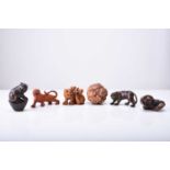 A group of six Japanese wood netsuke of tigers, 20th century