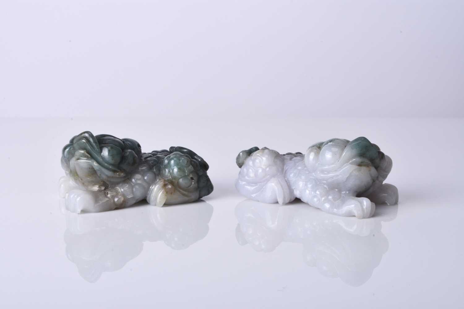A pair of Chinese jadeite figures of lion dogs, 20th century