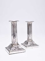 A pair of Edwardian short silver candlesticks