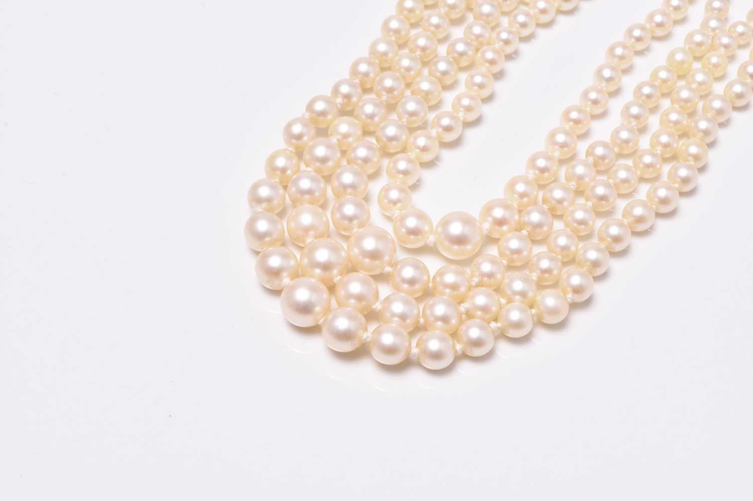 A four strand graduated cultured pearl necklace with 18ct white gold diamond set clasp