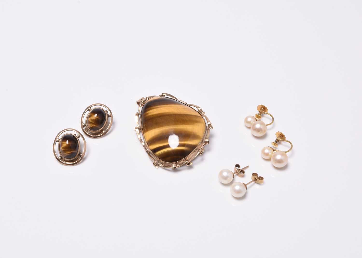 A brooch and three pairs of earrings