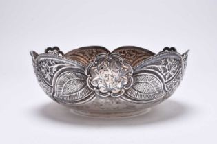 A decorative white metal bowl
