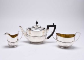 A matched three piece silver tea service