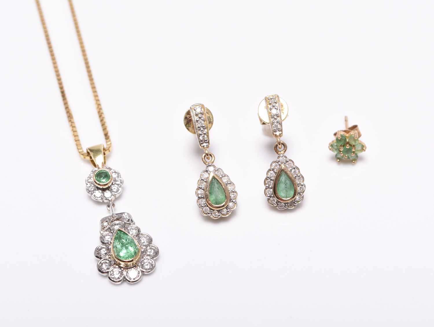 An emerald and diamond pendant on chain and a pair of earrings