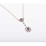 An early 20th century style 9ct gold sapphire set pendant on chain