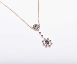 An early 20th century style 9ct gold sapphire set pendant on chain
