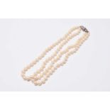 A two strand uniform cultured pearl necklace with diamond set clasp