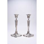 A pair of silver mounted candlesticks