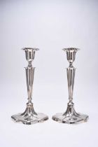 A pair of silver mounted candlesticks