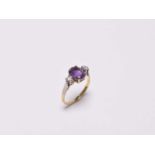 A three stone amethyst and diamond ring