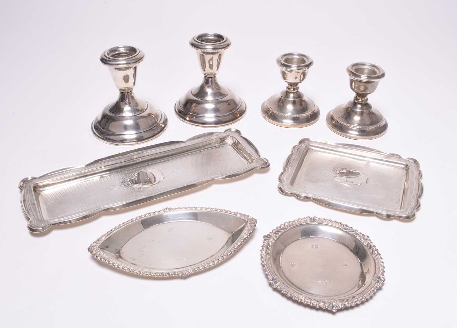 A small collection of silver and white metal