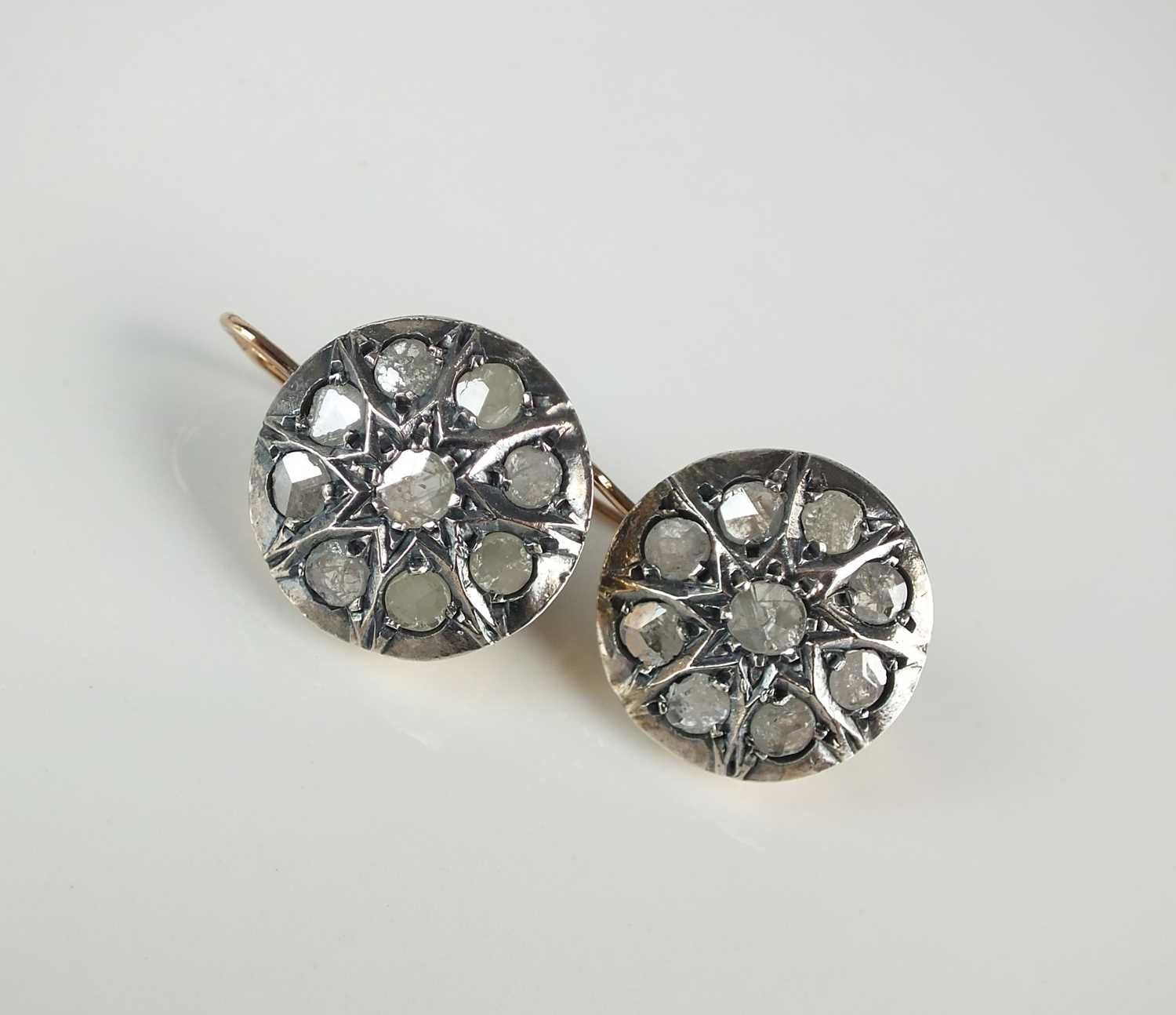 A pair of rose cut diamond circular cluster earrings