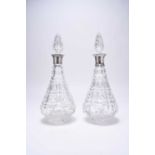 A matched pair of silver mounted cut glass decanters and six silver spoons