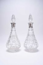 A matched pair of silver mounted cut glass decanters and six silver spoons