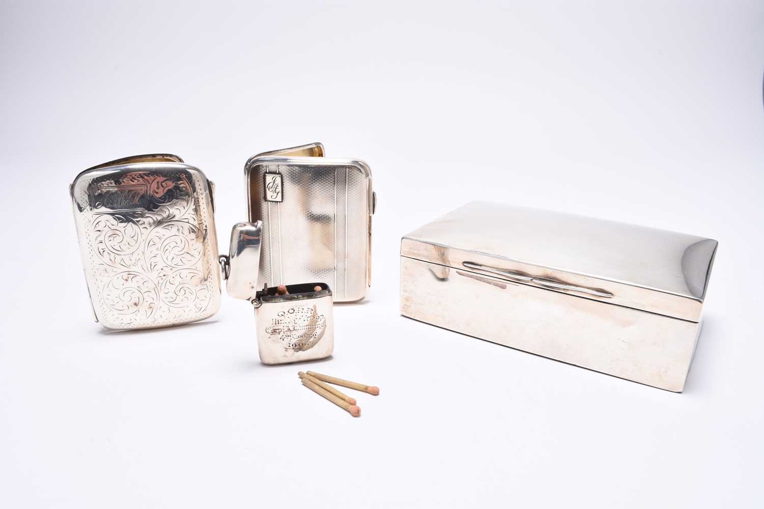 A silver mounted cigarette box, two silver cigarette cases and a vesta case