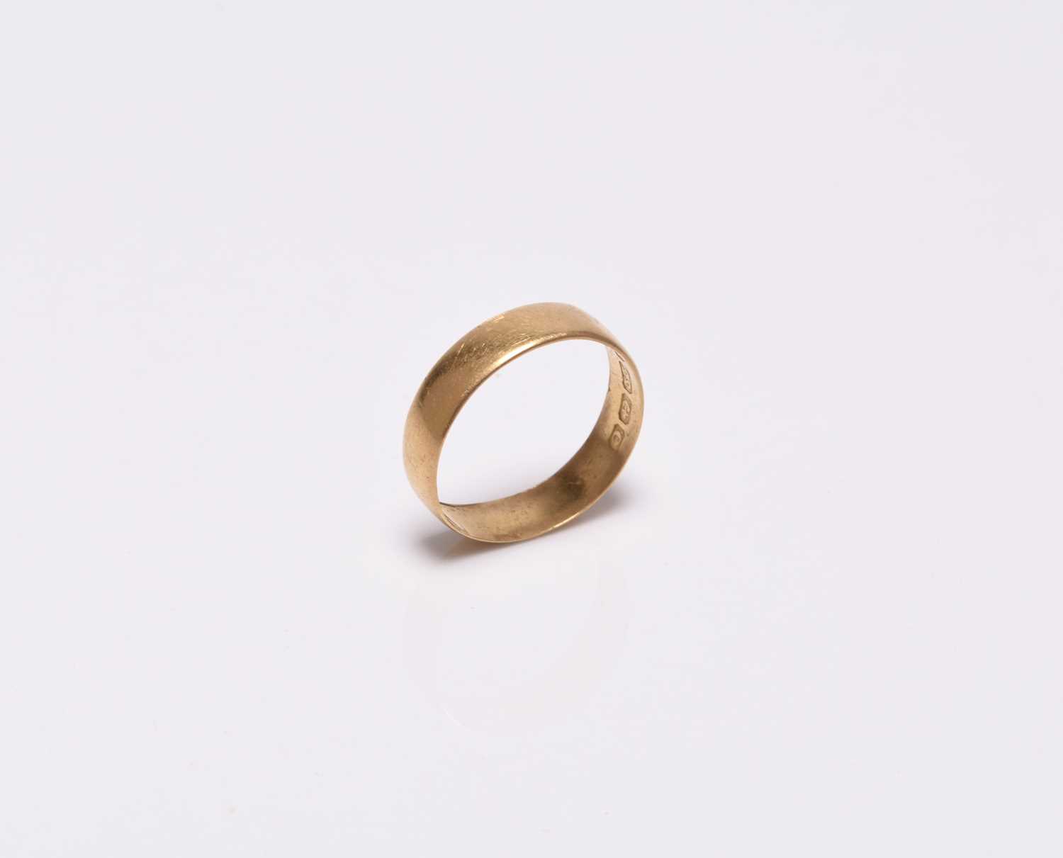 A plain polished 22ct gold wedding band