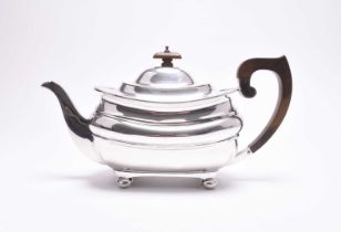 A silver teapot and sugar bowl