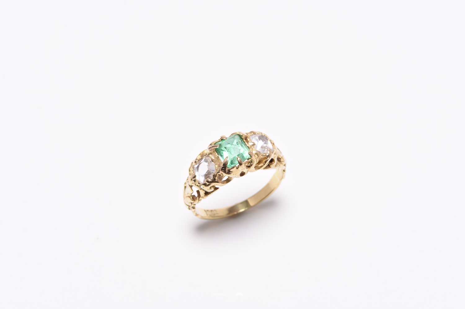 A late 19th century three stone emerald and diamond ring