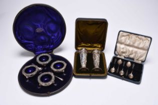 A cased set of four Edwardian silver salts and a cased pair of Victorian silver vases