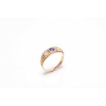 An early 20th century three stone untested sapphire and diamond ring