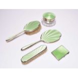 A five piece silver and green enamel mounted dressing table set