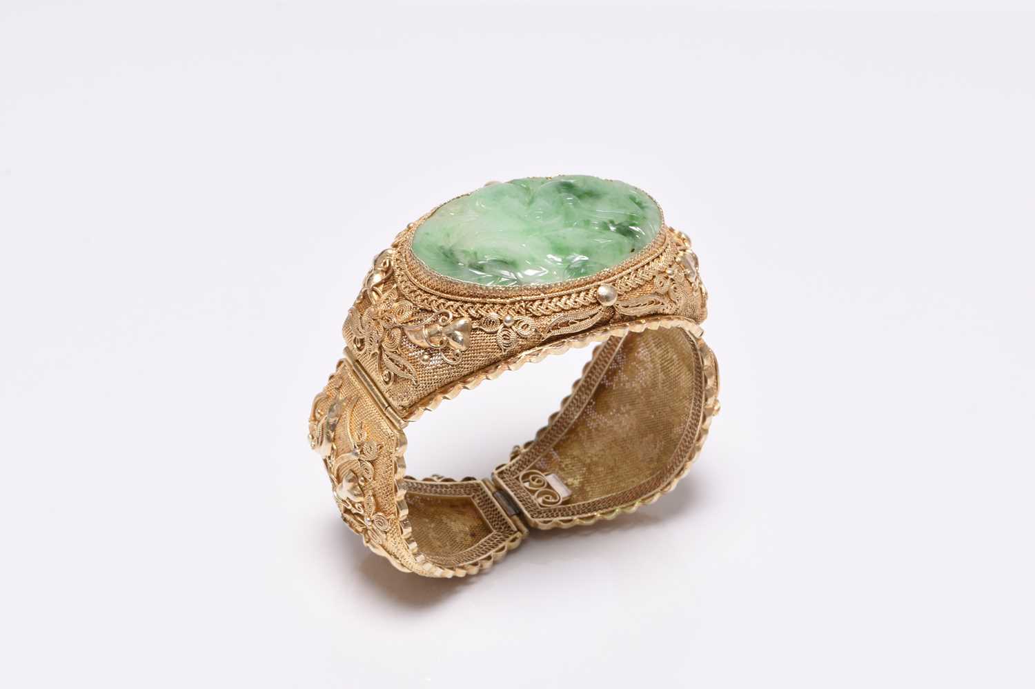 A jade and gilt metal bangle and a pair of jade earrings