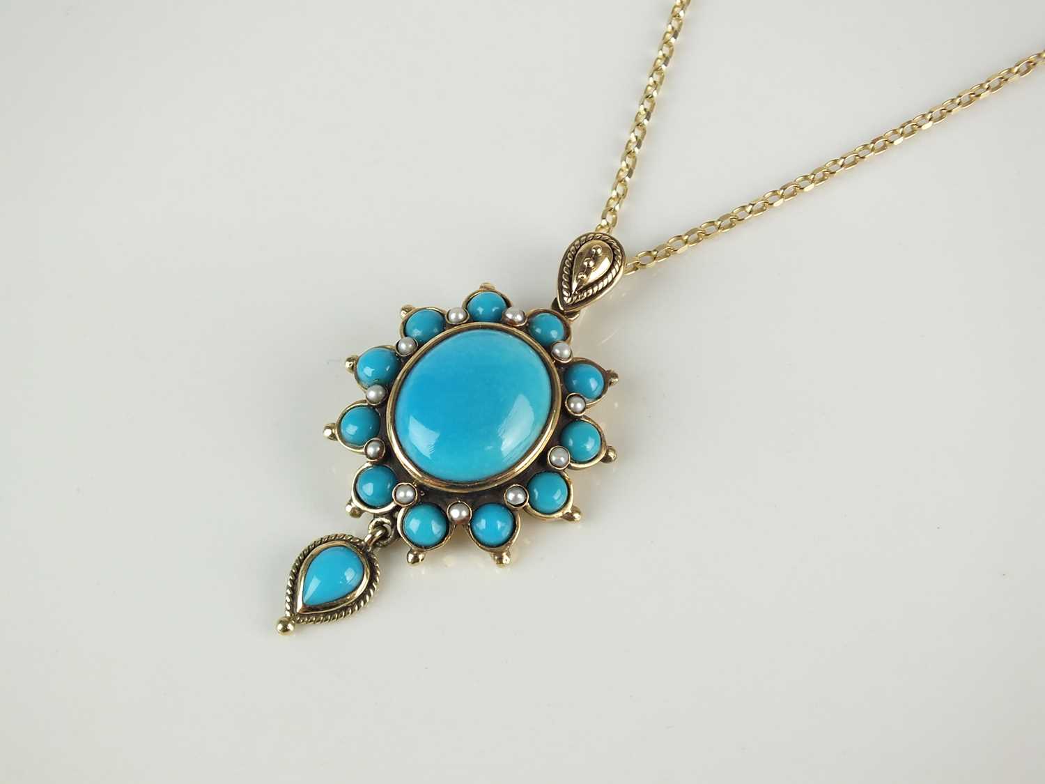 A turquoise and split pearl pendant on chain