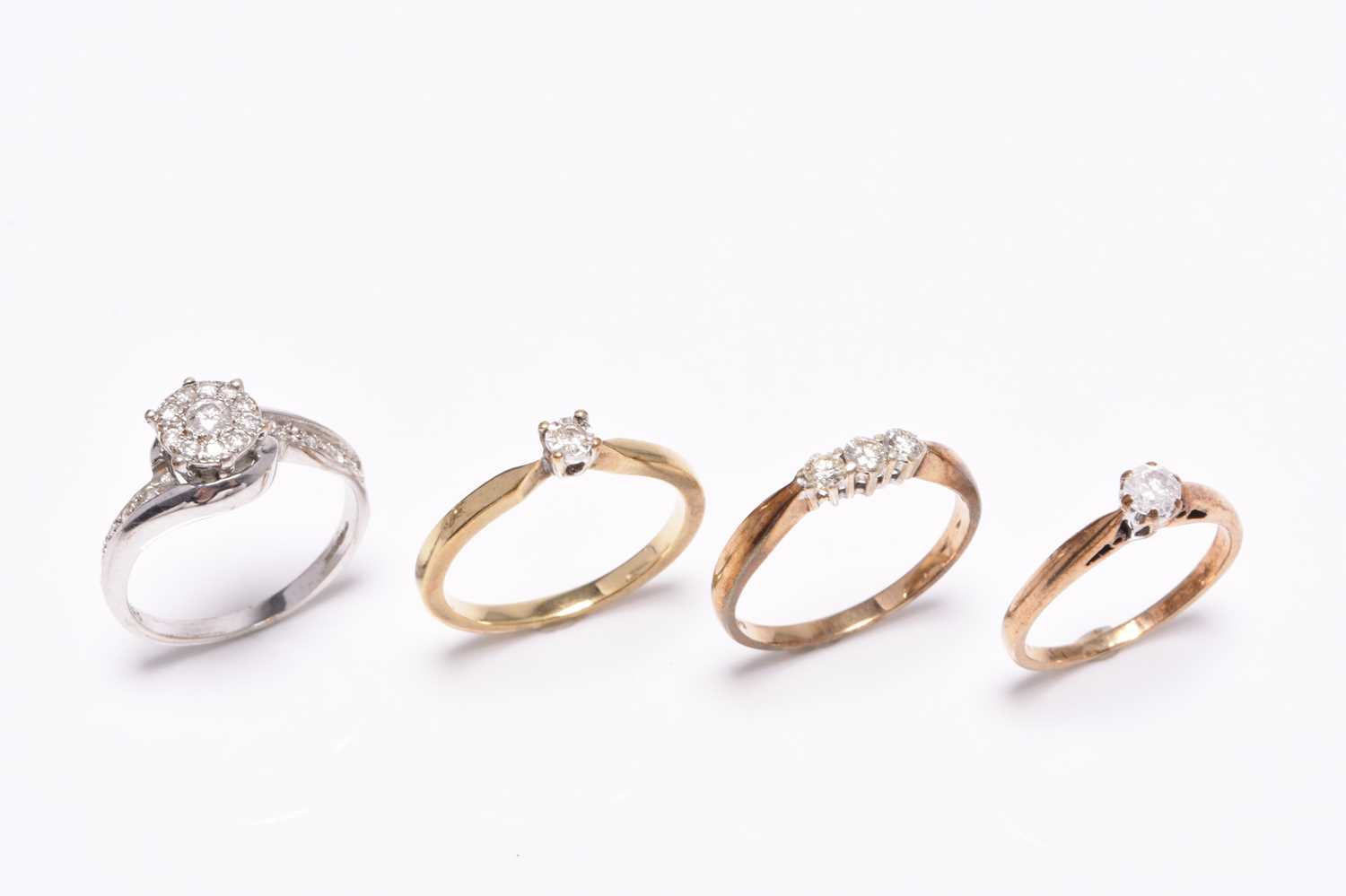 Four 9ct gold diamond set rings
