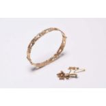 A 9ct gold bangle and a seed pearl brooch