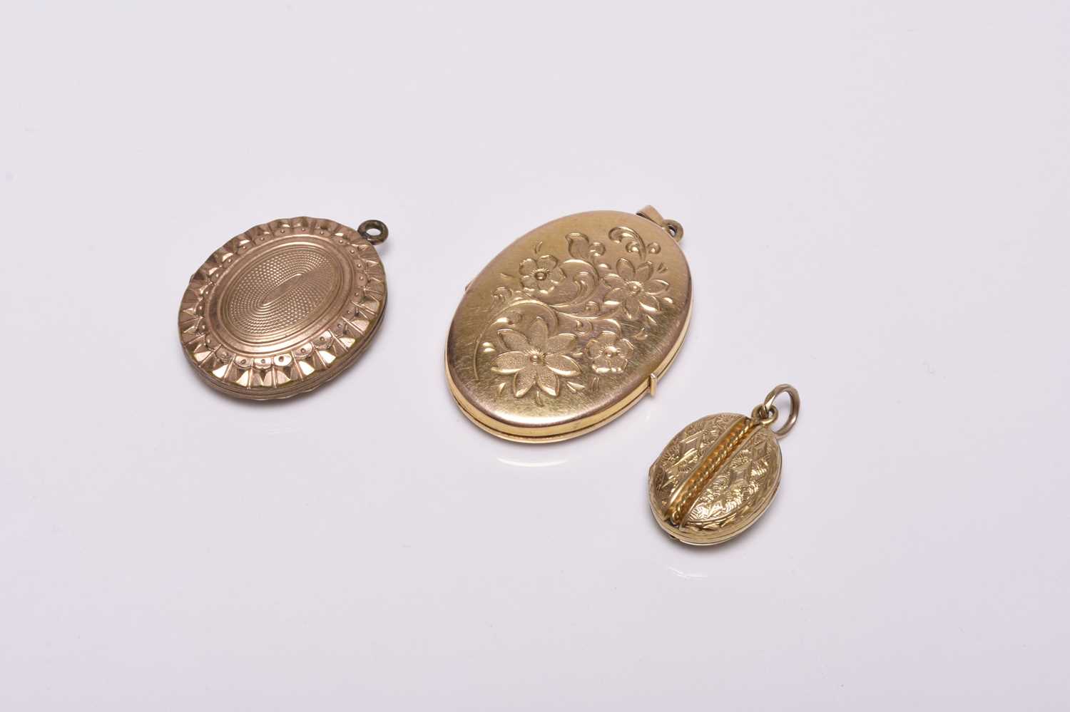 Three oval locket pendants