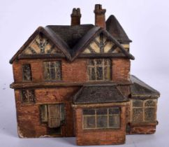 A CHARMING ANTIQUE CARVED AND PAINTED FOLK ART WOOD FIGURE OF A HOUSE C1918. 14 cm x 12 cm.