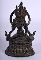 A 19TH CENTURY INDIAN TIBETAN BRONZE FIGURE OF A SEATED BUDDHA modelled upon a triangular base. 12