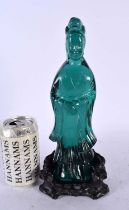A RARE CHINESE QING DYNASTY GREEN PEKING GLASS FIGURE OF AN IMMORTAL modelled upon a fitted hardwood