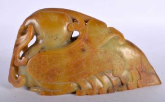 A 19TH CENTURY CHINESE CARVED JADE FIGURE OF A STYLISED BIRD Qing. 18 cm x 12 cm.