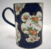 18th century Worcester mug painted in kakiemon style with two panels of oriental flowers on a blue