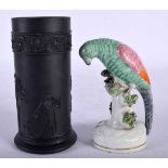 A 19TH CENTURY STAFFORDSHIRE FIGURE OF A PARROT together with a wedgwood black basalt vase.