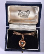 A Boxed Antique 9ct Gold Ribbon and Heart Brooch, stamped 9ct. 3.7cm x 3cm, weight 3.7g