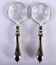 A PAIR OF SILVER PLATED MAGNIFYING GLASSES. 9.75 cm x 3.25 cm.