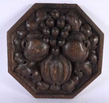 AN ARTS AND CRAFTS CARVED OAK FRUITING POD PLAQUE. 20cm wide.