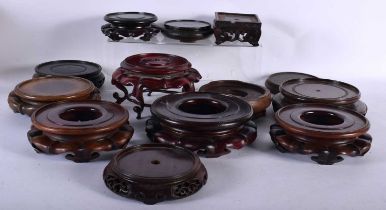 A LARGE COLLECTION OF 19TH/20TH CENTURY CHINESE HARDWOOD STANDS Qing. Largest 17 cm diameter. (qty)