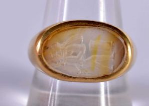 An 18ct Gold Ring set with a Crystal Seal. Size R, weight 9.59g