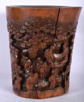 A 19TH CENTURY CHINESE CARVED BAMBOO BRUSH POT BITONG Qing, carved with figures in landscapes. 19 cm